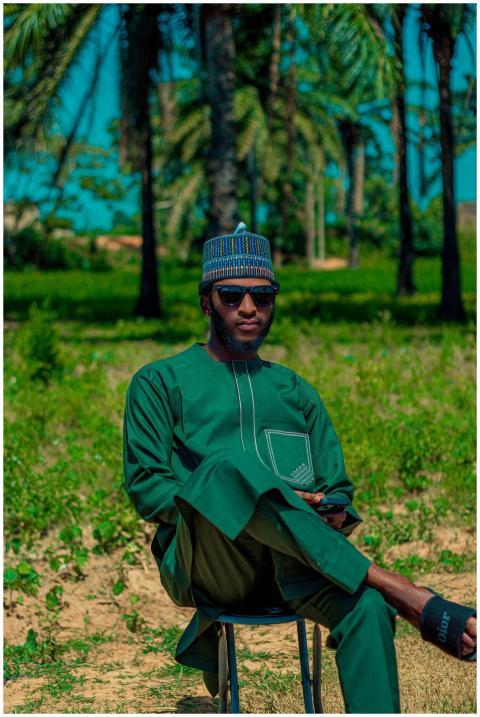 Man sitting outdoors in colorful traditional attir