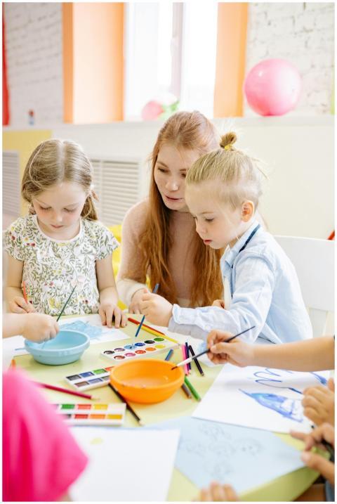 Kids and teacher enjoying a vibrant art activity i