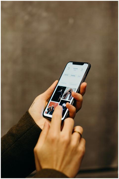 Close-up of hands using a smartphone to browse a p