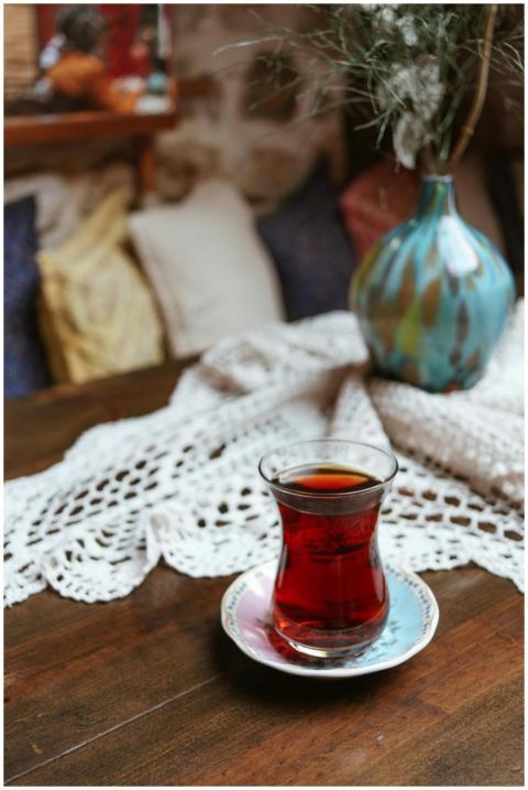 Turkish tea in a tulip glass on a rustic wooden ta