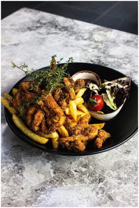A savory platter of fried chicken with fries and s
