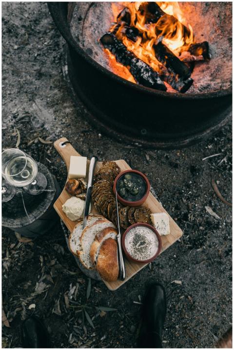 Enjoy a rustic picnic with cheese, bread, and wine