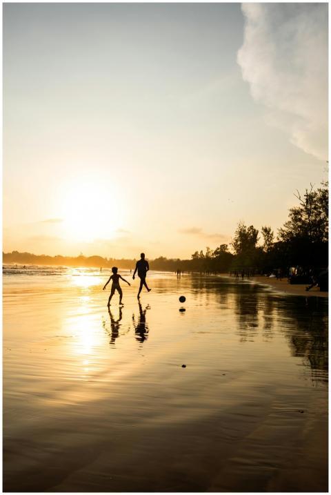 Silhouette of two people playing soccer on Weligam