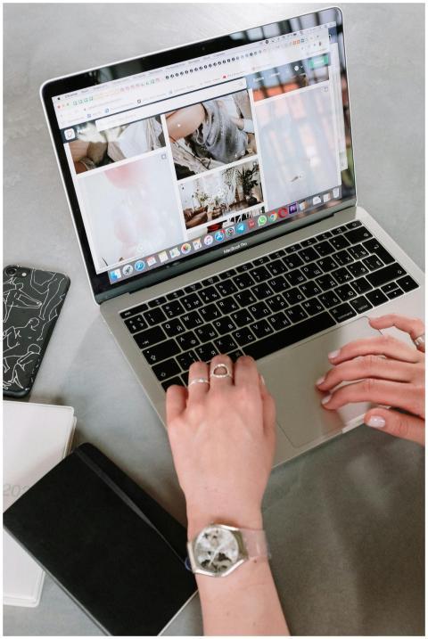 A close-up of a woman's hands browsing an online a