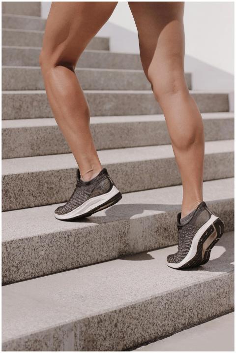 Dynamic shot of athletic legs in sneakers climbing