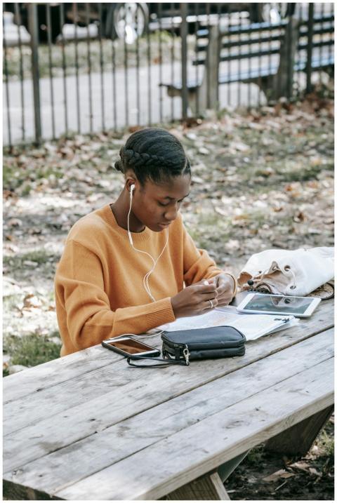 Young concentrated African American female using s