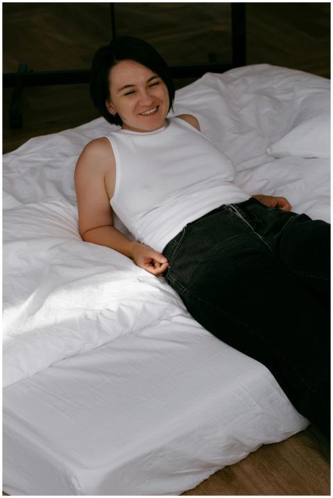 Casual, relaxed woman smiling while lying on a min