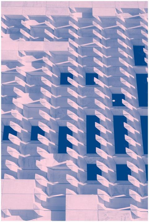 Abstract geometric facade with striking shadows in