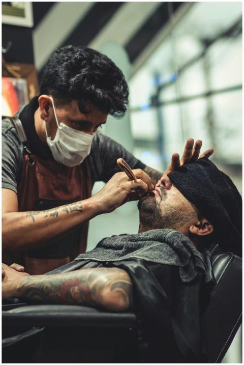 Barber expertly shaves a client's beard in a styli