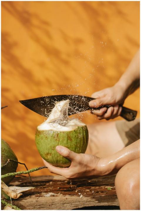 Vibrant image of a fresh green coconut being cut o