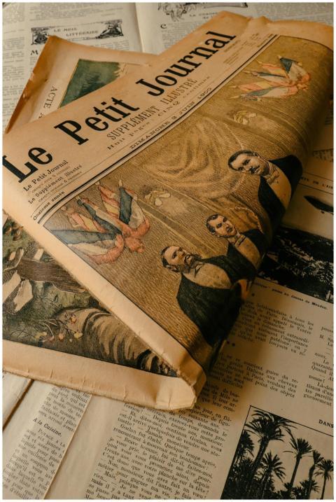 A vintage edition of 'Le Petit Journal' with histo
