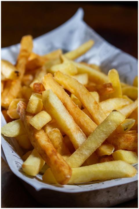 Close-up of golden crispy french fries served in a
