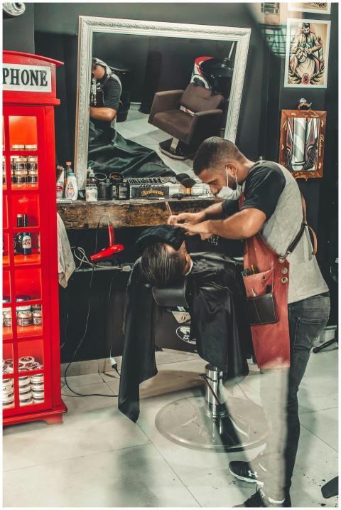 Barber performing a haircut in a stylish barbersho