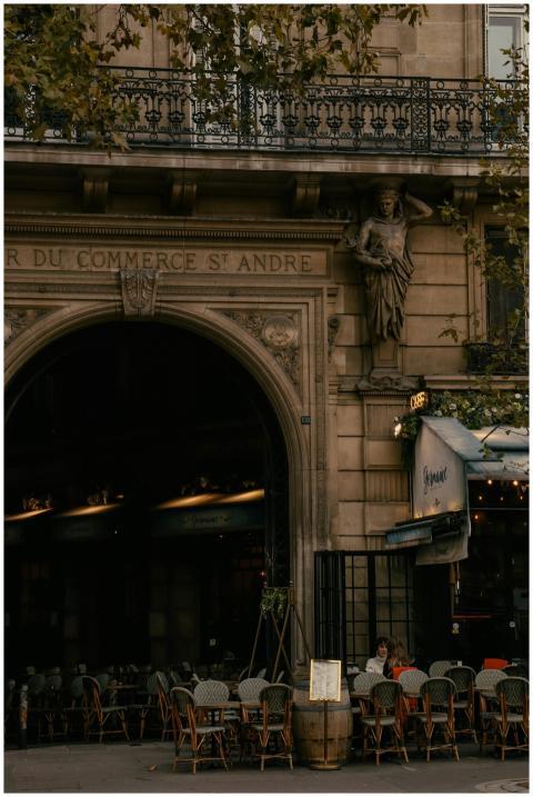 A peaceful Parisian street cafe under classic arch