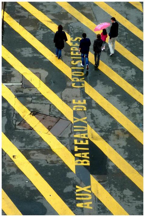 Aerial view of people walking on a marked street w