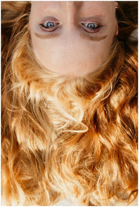Up-close view of golden blonde hair and blue eyes