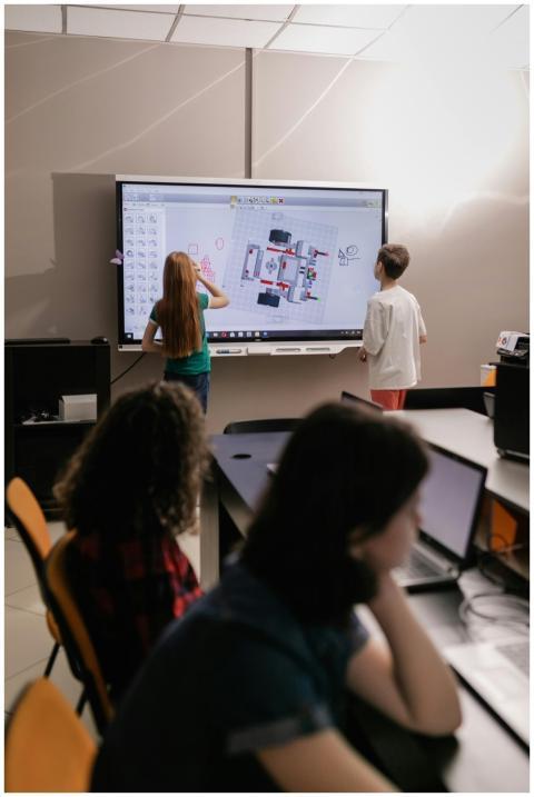 Kids learning with an interactive board in a moder