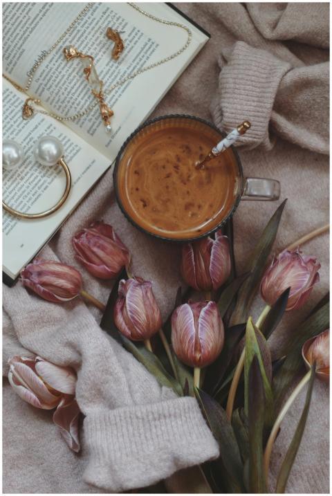 A warm, inviting scene of coffee, purple tulips, a