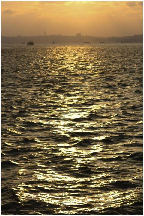 Beautiful sunset over calm ocean with golden refle