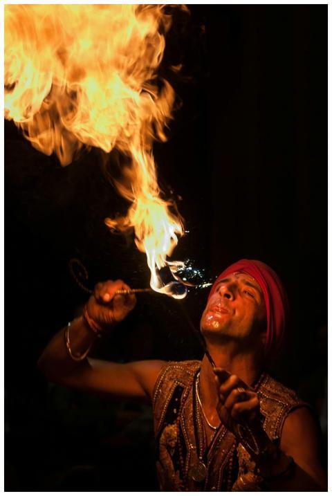 Male fire performer displays impressive fire eatin