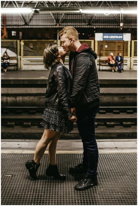Young couple sharing a romantic moment on a railwa