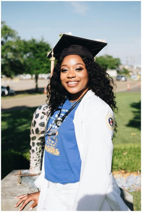 Smiling graduate in Baton Rouge celebrating her ac