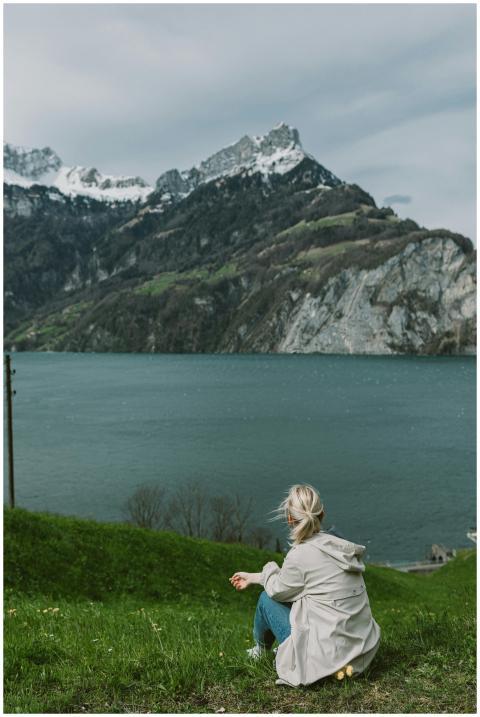 A serene moment of a woman in a coat sitting by a