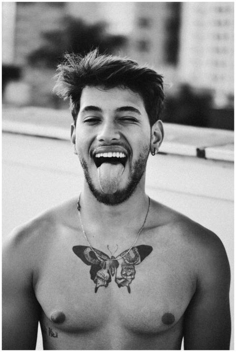 Artistic black and white portrait of a tattooed ma