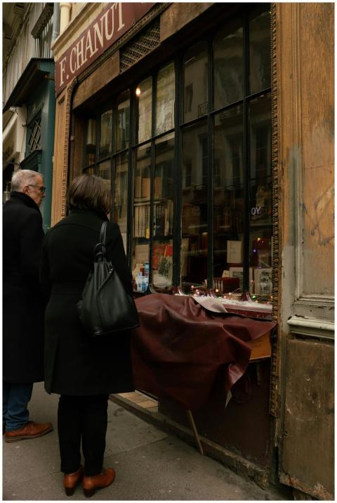 A couple explores a vintage bookshop in the quaint