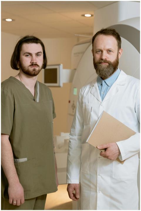 Two healthcare professionals standing by MRI scann