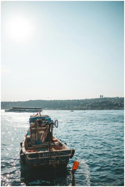 A serene view of a fishing boat on calm ocean wate