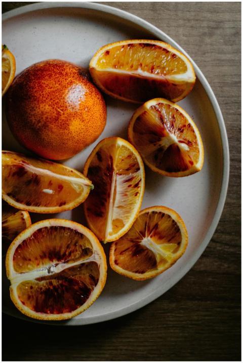 Freshly sliced blood oranges arranged on a ceramic