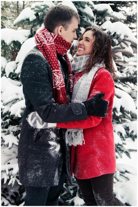 Couple enjoying a loving embrace in a snowy forest