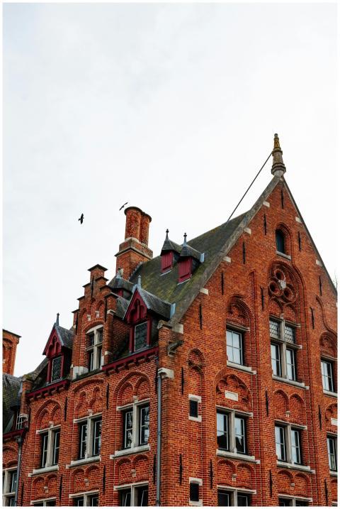 Brick building facade in Bruges showcasing Gothic