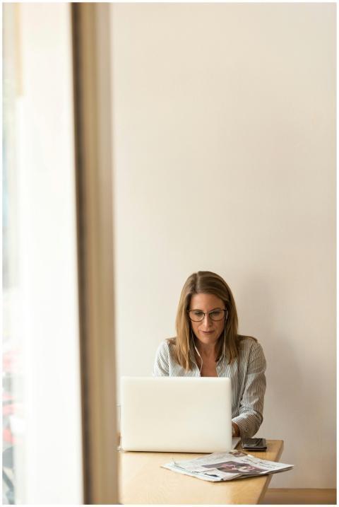 Businesswoman working remotely on a laptop at home