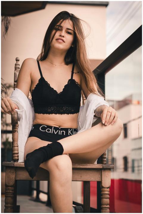 A young woman exudes confidence while posing outdo