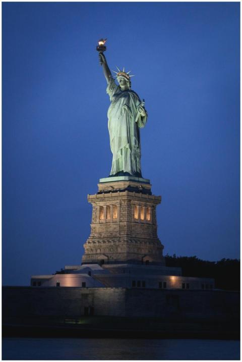 Stunning nighttime view of the Statue of Liberty o