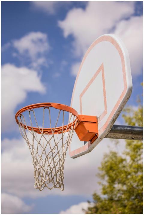 Low angle of basketball ring hanging on backboard