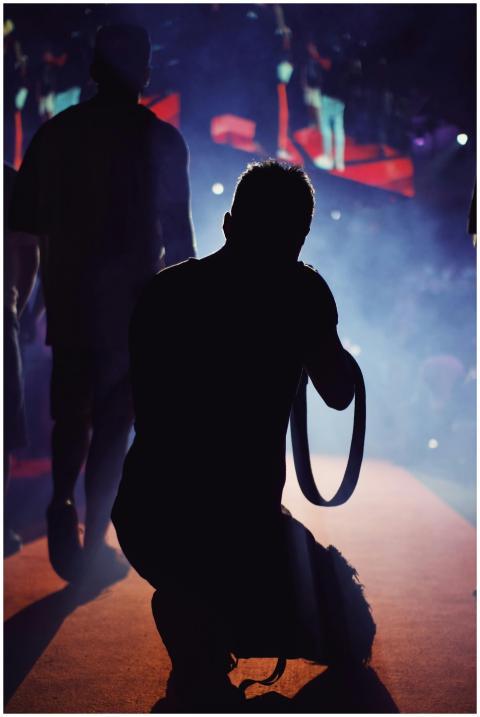 A talented photographer capturing a dynamic live m