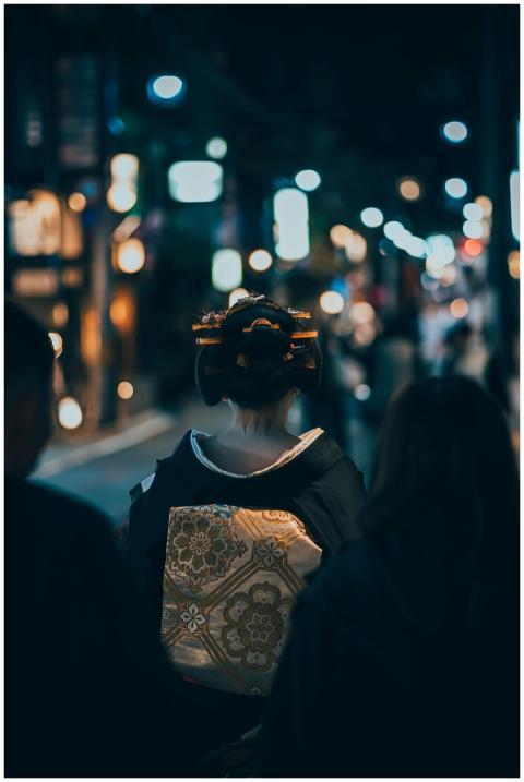 A geisha walks through Kyoto's night streets, show