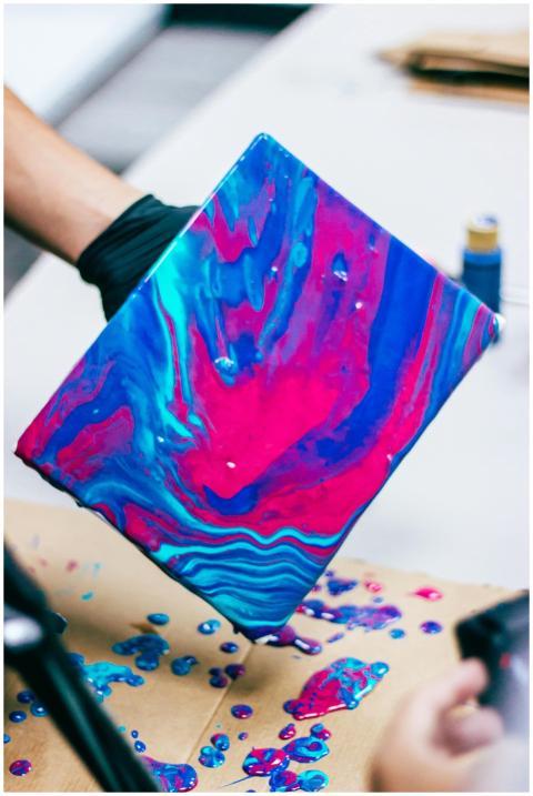 Colorful abstract acrylic pour painting process on