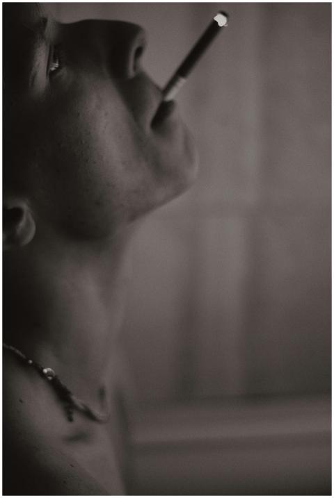 Dramatic black and white portrait of a man smoking
