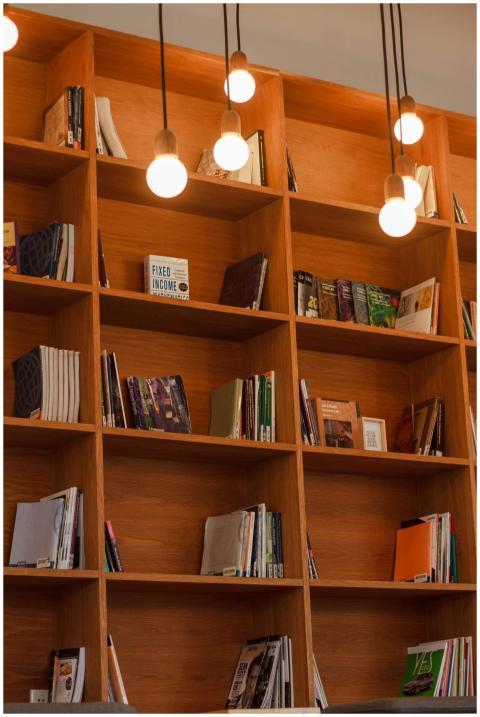 Wooden bookshelves filled with various books and w