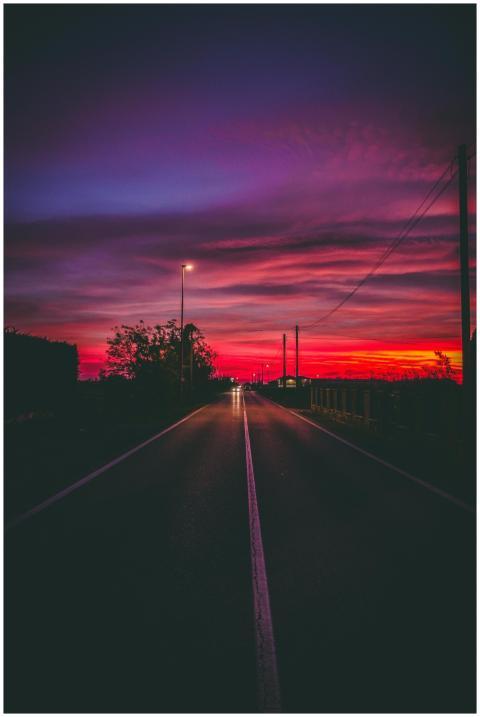 A captivating night view of a road under a dramati