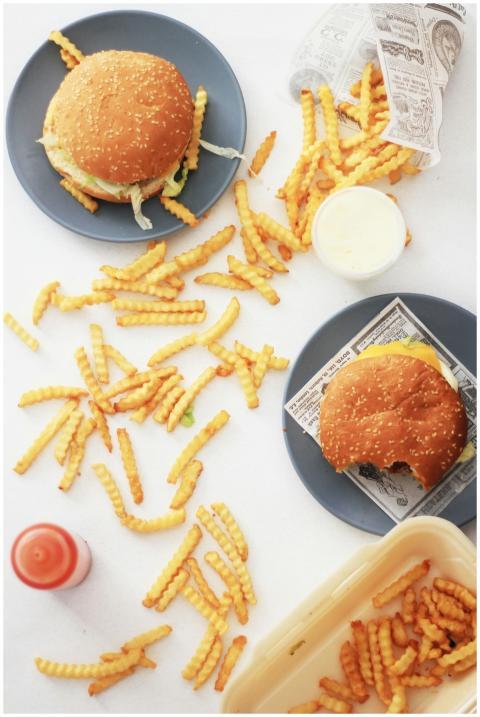 Flat lay of cheeseburgers and crinkle-cut fries on