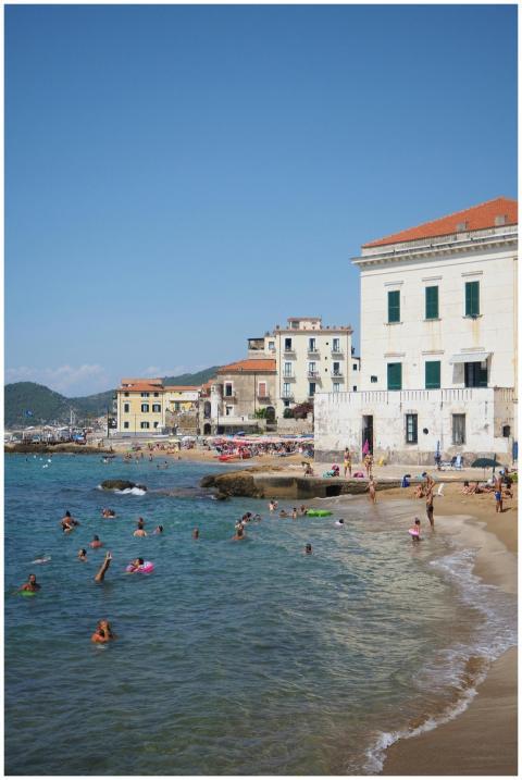 A lively beach scene in a Mediterranean town with