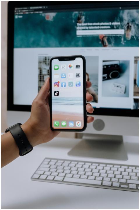 Close-up of a hand holding a smartphone showing so