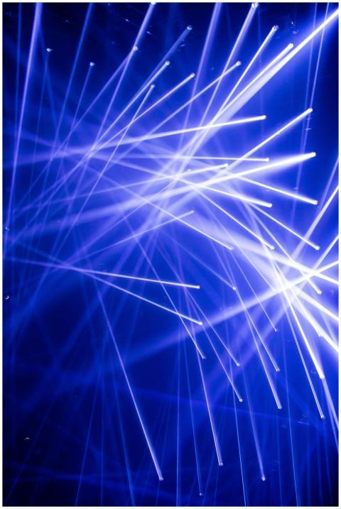 Vibrant blue laser light beams creating an abstrac