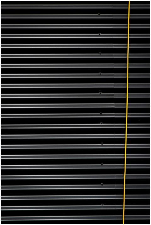 Close-up of a corrugated metal panel with a bold y