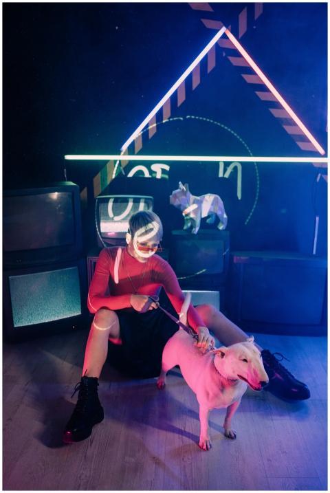 A woman with a bull terrier in a vibrant cyberpunk